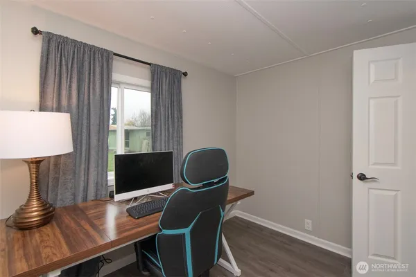 a workspace with furniture and wooden floor