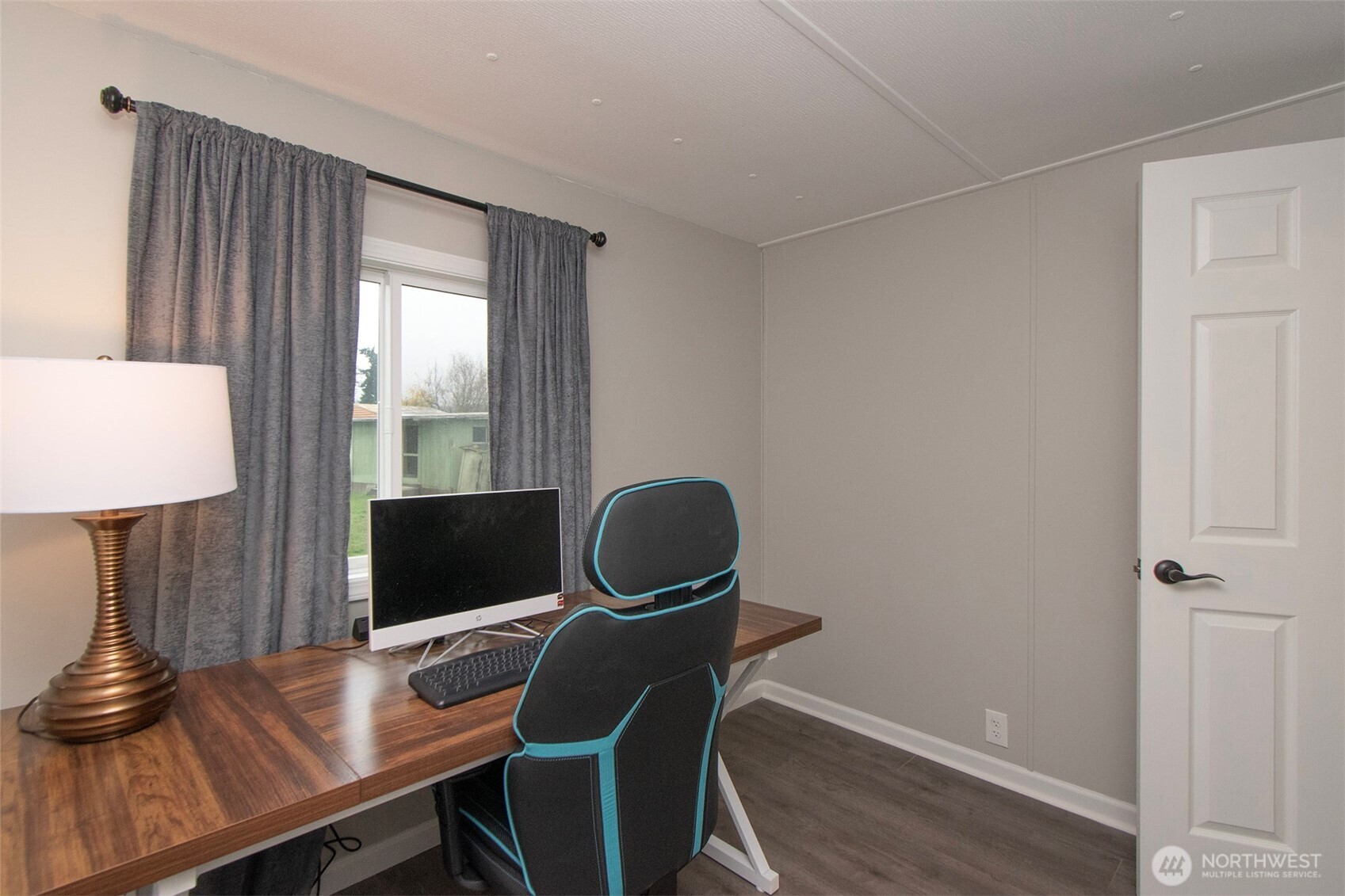 491 Mill Road, Unit 30 Sequim, WA 98382 - Photo 23 of 39 a workspace with furniture and wooden floor