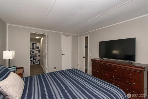 a bedroom with a bed and a flat screen tv