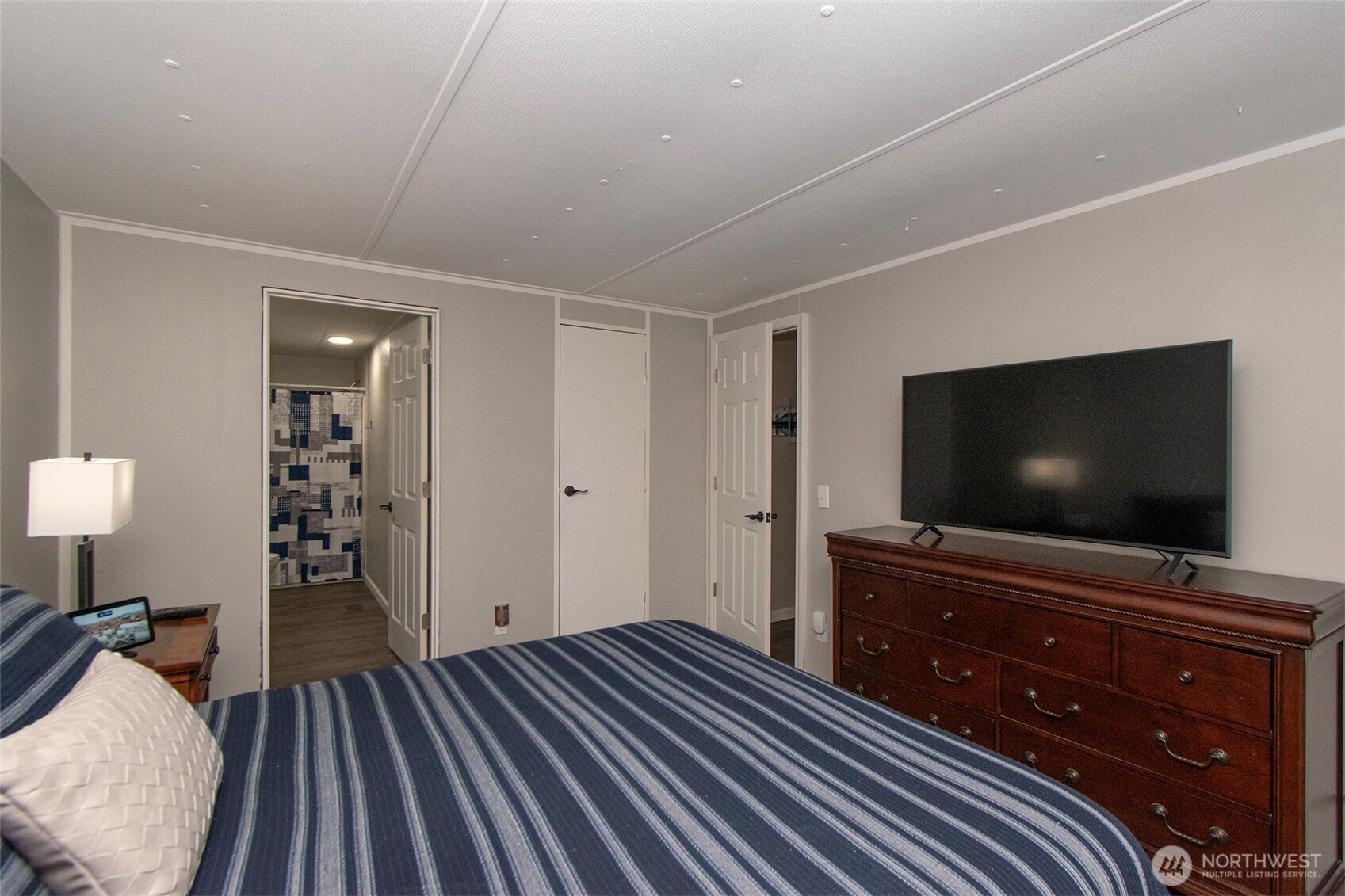 491 Mill Road, Unit 30 Sequim, WA 98382 - Photo 26 of 39 a bedroom with a bed and a flat screen tv