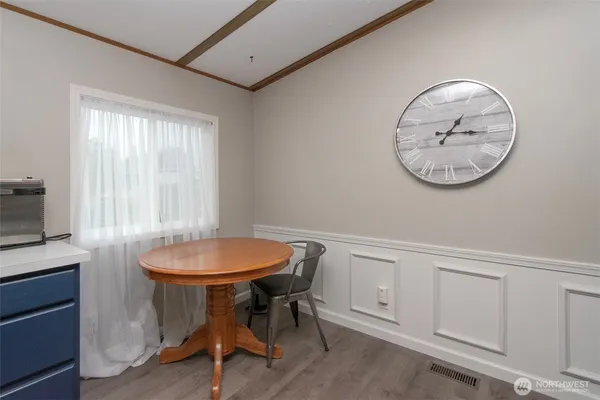 a view of a room that has a table and a chair in it