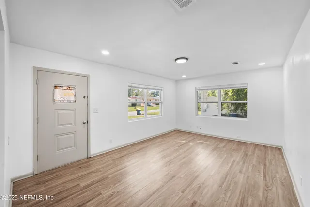 wooden floor in an empty room with a window