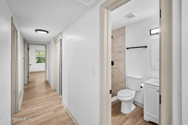 a bathroom with a toilet shower and a sink