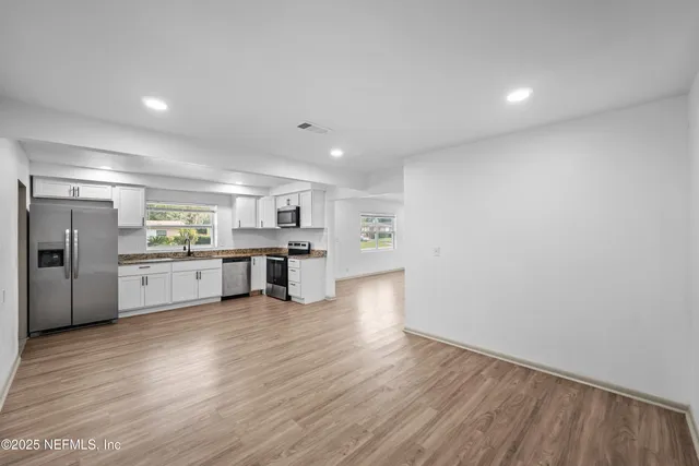 a view of kitchen with wooden floor