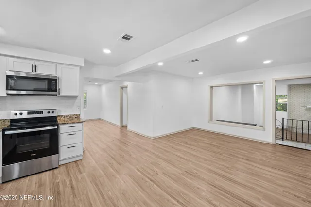 a view of kitchen with microwave and stove