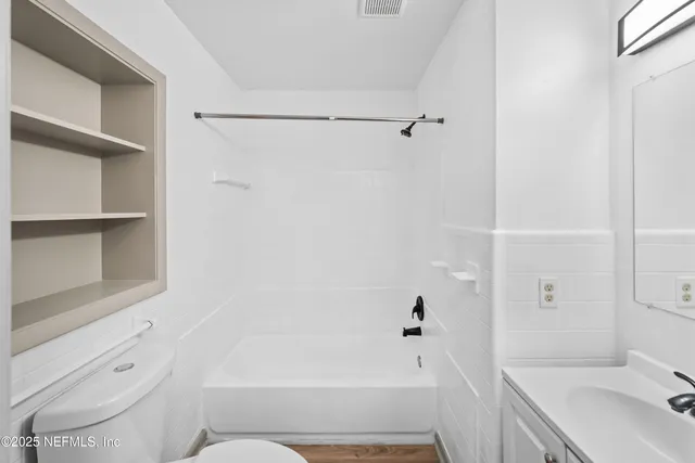 a bathroom with a sink a toilet and mirror