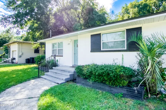 a front view of house with yard and green space