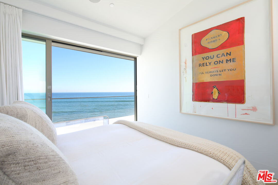 23956 Malibu Road Malibu, CA 90265 - Photo 15 of 26 a bedroom with a bed and a painting on the wall