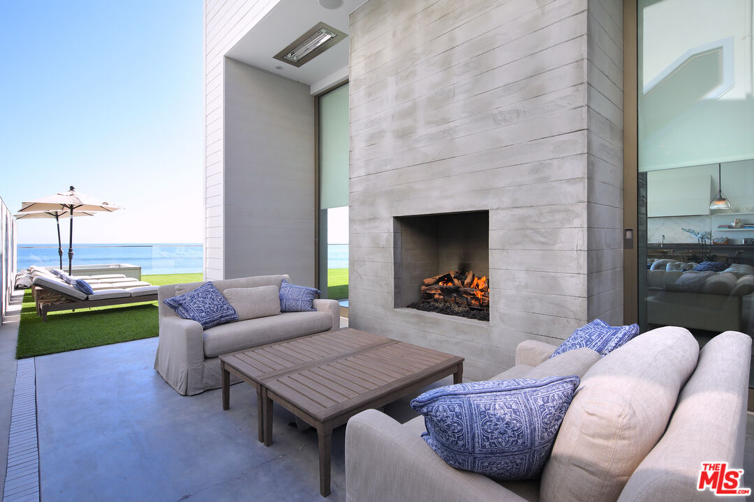 23956 Malibu Road Malibu, CA 90265 - Photo 10 of 26 a living room with furniture and a fireplace