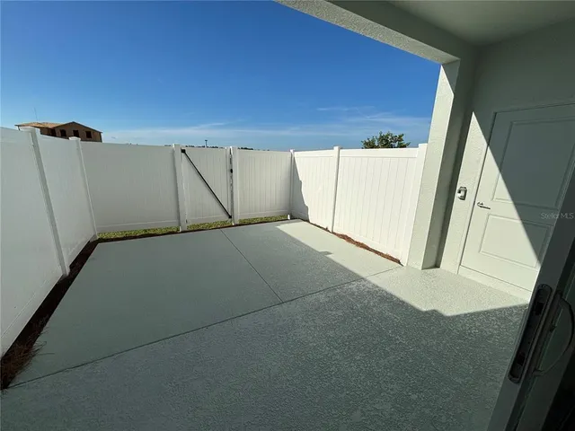 a view of a house with a yard and potted plants