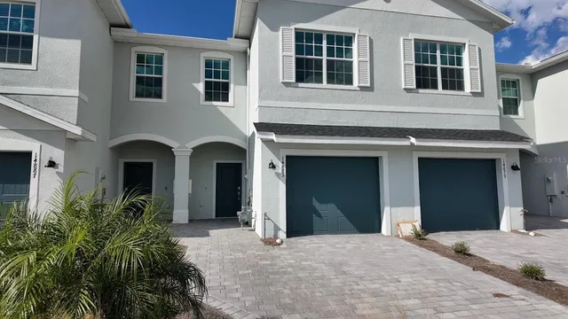 a view of a house with potted plants