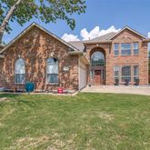 a front view of a building with a garden