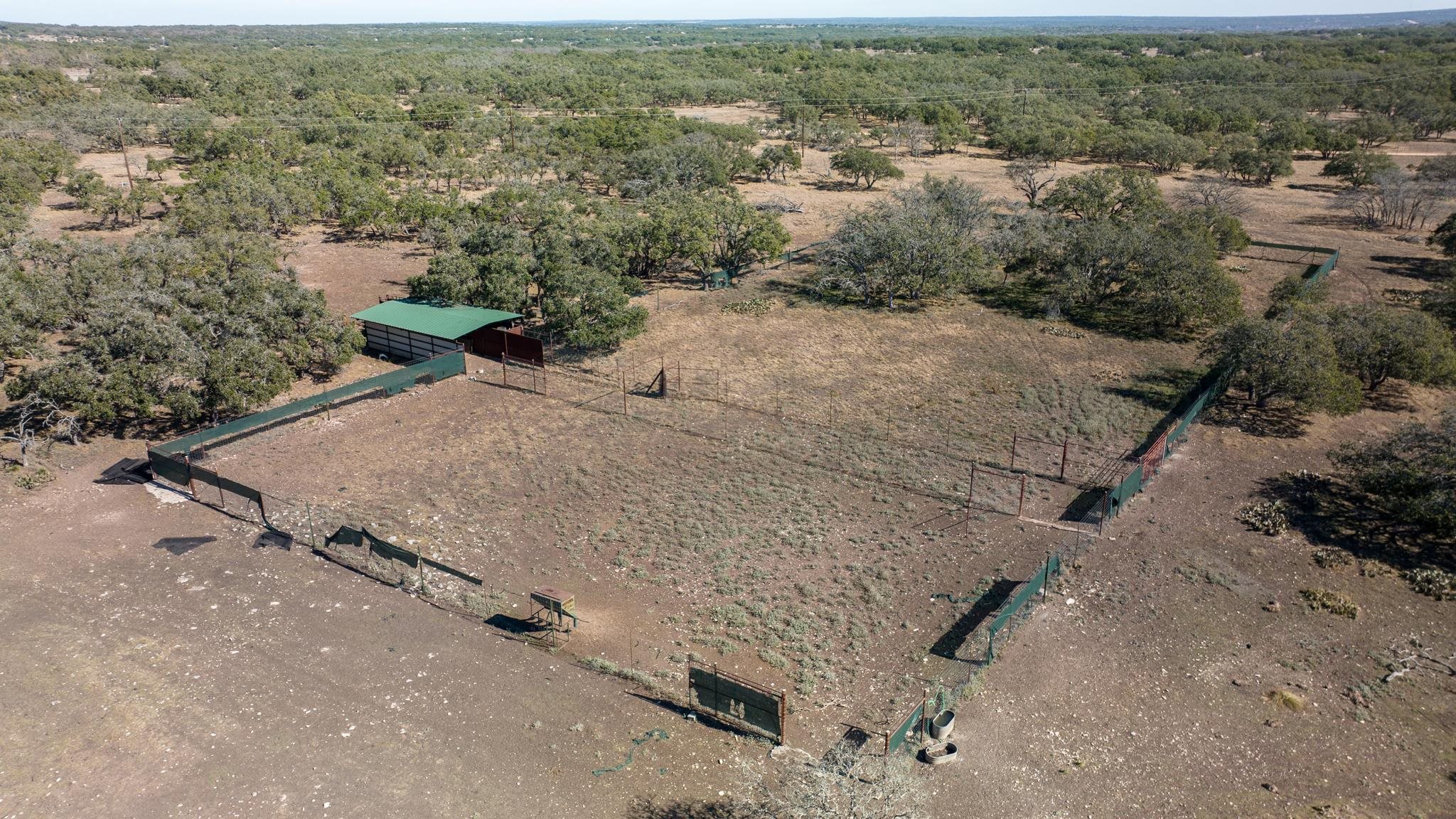 251 Blackjack Ranch Road Harper, TX 78631 - Photo 10 of 16 an aerial view of a house with a yard and lake view in back