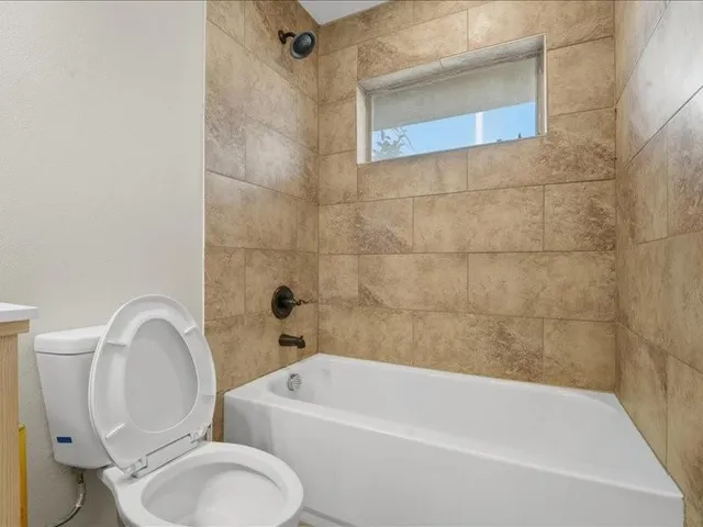 a bathroom with a toilet and a bathtub