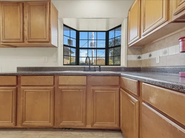 a kitchen with stainless steel appliances granite countertop a refrigerator and cabinets