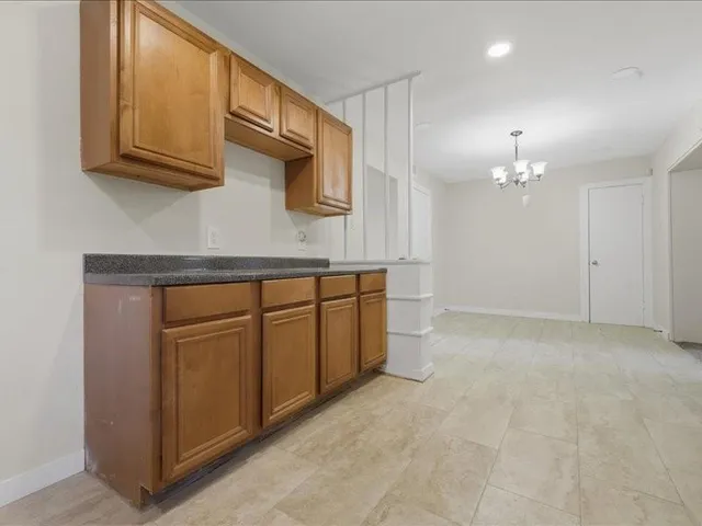 a view of a kitchen with microwave and cabinets