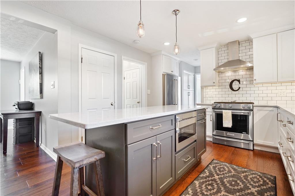 732 Venango Avenue Pittsburgh, PA 15209 - Photo 6 of 25 Accented in gray, the center island features a built in drawer microwave, large work area and contemporary lighting.
