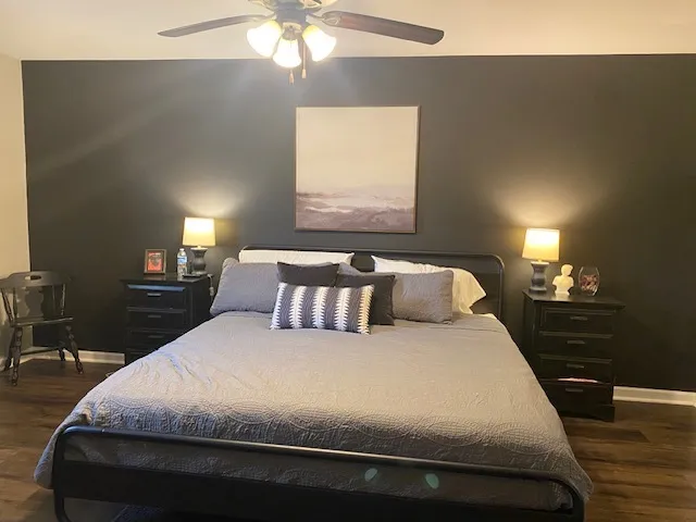 a bedroom with a bed and a chandelier