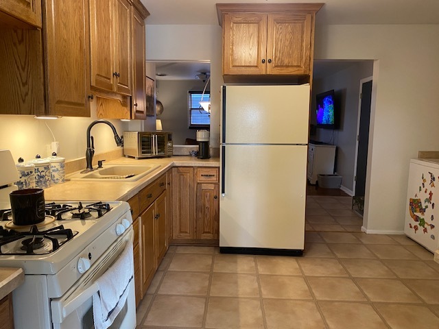 727 15th Street Peru, IL 61354 - Photo 4 of 20 a kitchen with a refrigerator sink and cabinets