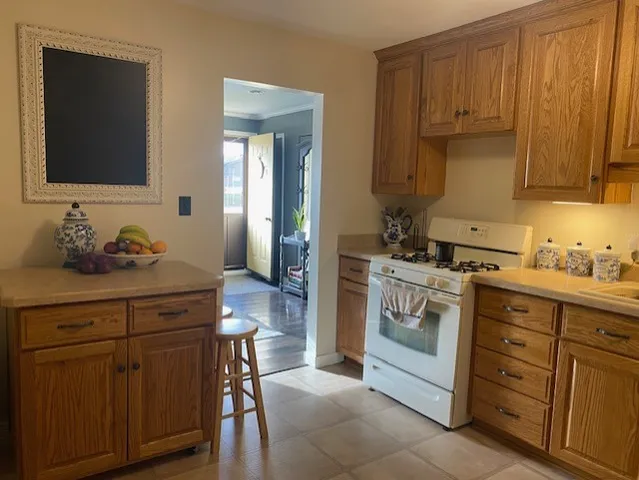 a kitchen with stainless steel appliances granite countertop a sink stove and cabinets