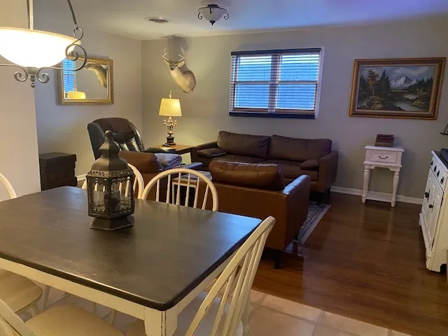 a living room with furniture and wooden floor