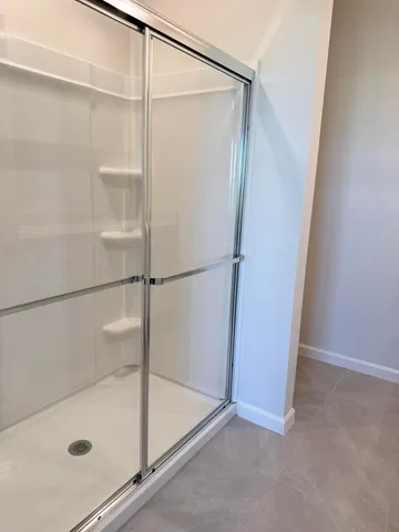 a bathroom with a glass shower door