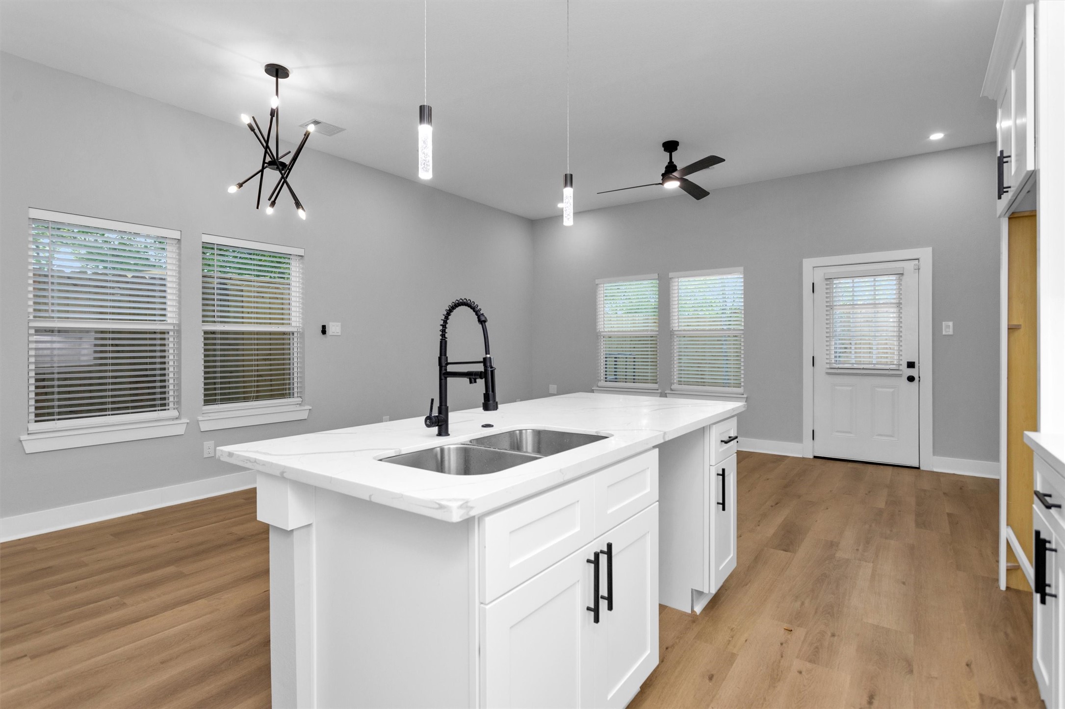 6918 Dumble Street, Unit B Houston, TX 77021 - Photo 14 of 31 a kitchen with a sink chandelier and wooden floor