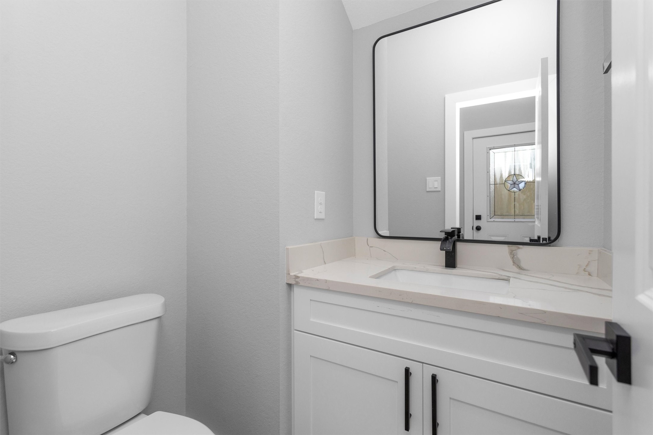 6918 Dumble Street, Unit B Houston, TX 77021 - Photo 15 of 31 a bathroom with a toilet sink and mirror