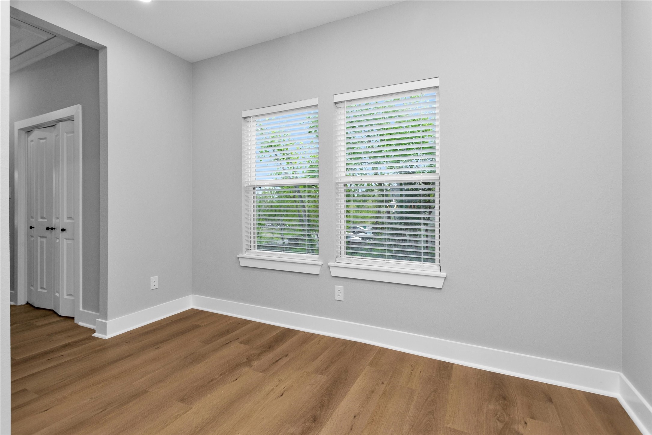6918 Dumble Street, Unit B Houston, TX 77021 - Photo 16 of 31 a view of an empty room with wooden floor and a window