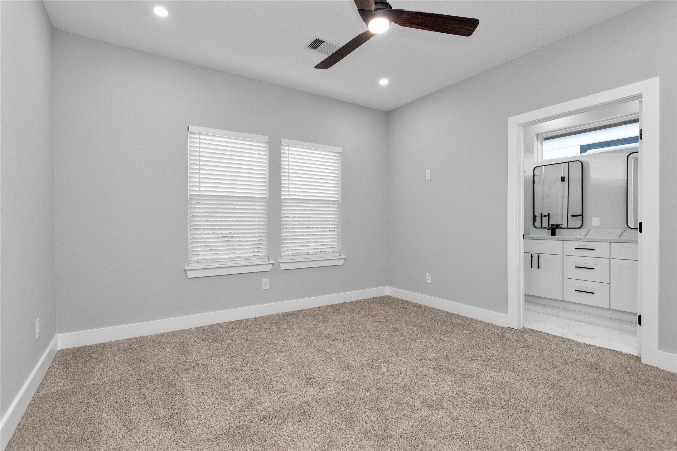 6918 Dumble Street, Unit B Houston, TX 77021 - Photo 19 of 31 an empty room with windows and fan