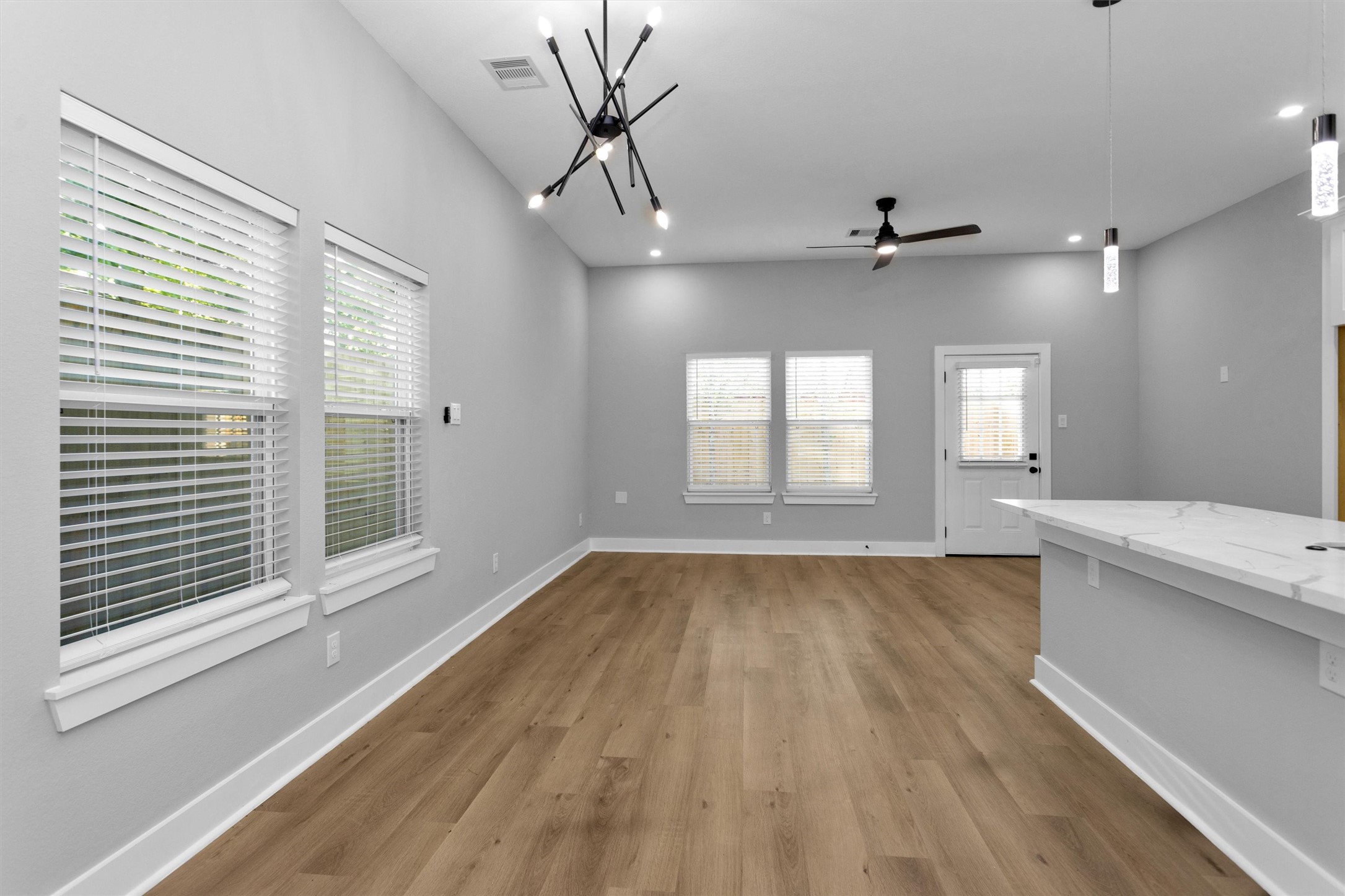 6918 Dumble Street, Unit B Houston, TX 77021 - Photo 6 of 31 a view of an empty room with a window and wooden floor