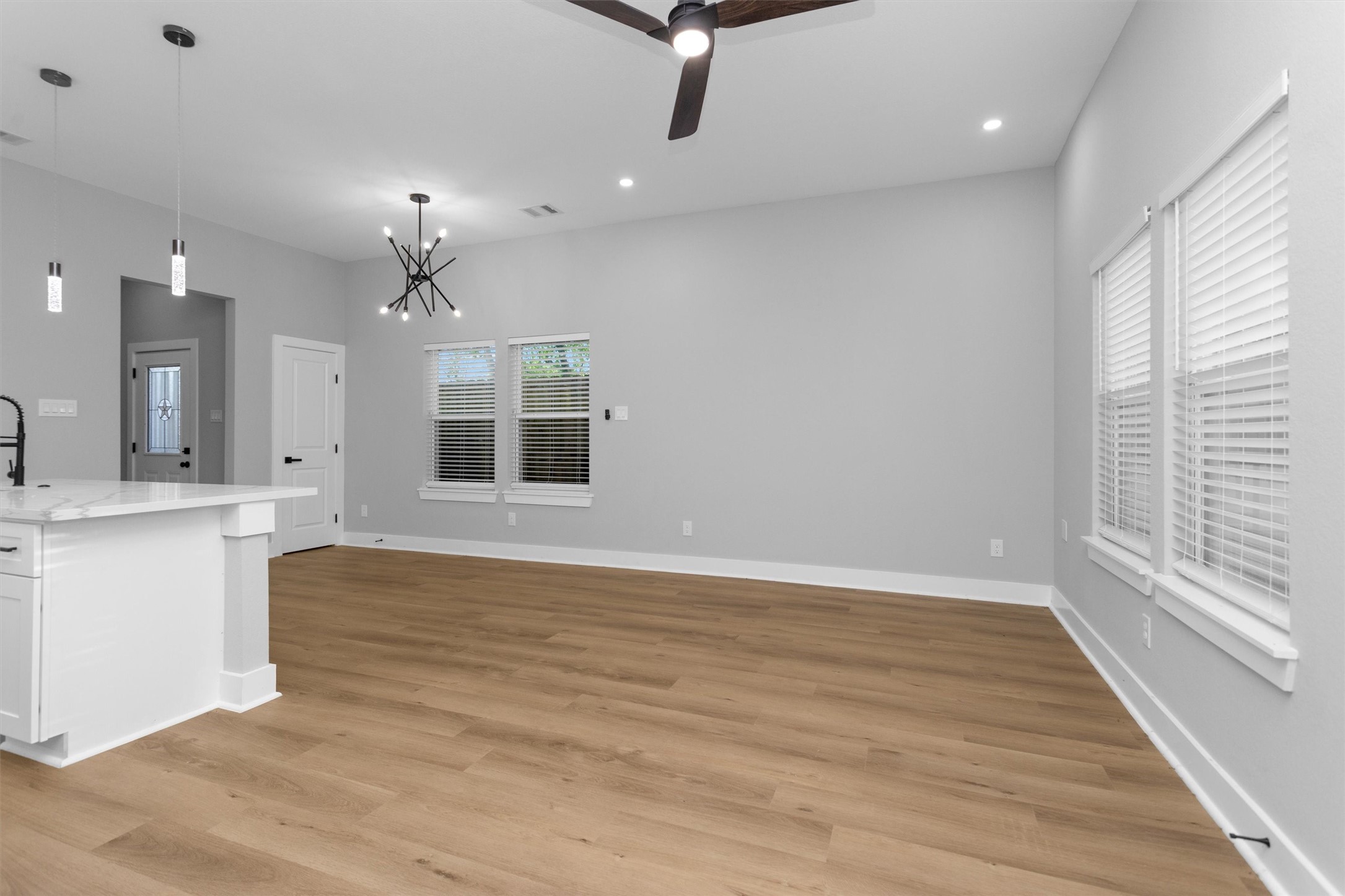 6918 Dumble Street, Unit B Houston, TX 77021 - Photo 10 of 31 a view of an empty room with wooden floor and a window