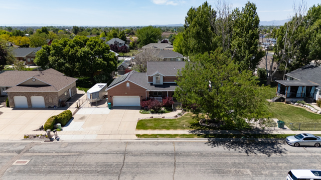 5727 South 3550th Street West Roy, UT 84067 - Photo 39 of 49 Brick and siding exterior with a multi-gabled roofline
