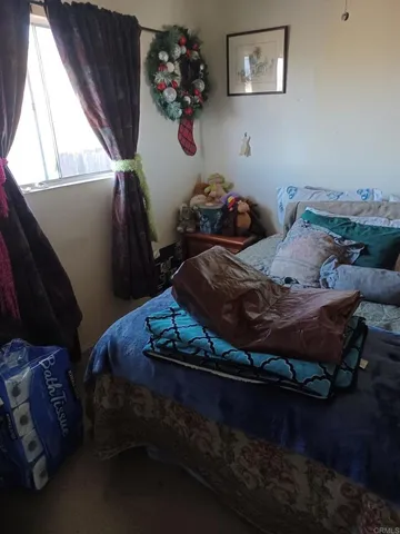 a bed sitting in a bedroom next to a window