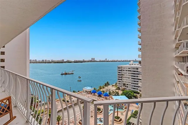 a kitchen with stainless steel appliances kitchen island granite countertop a table and chairs in it