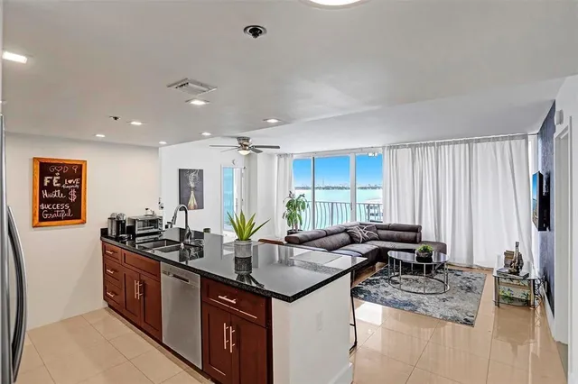 a kitchen with a refrigerator and a counter top space