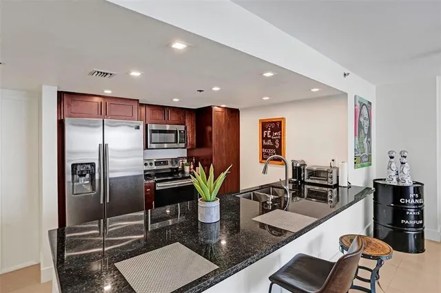 a kitchen with granite countertop a sink and a counter top space
