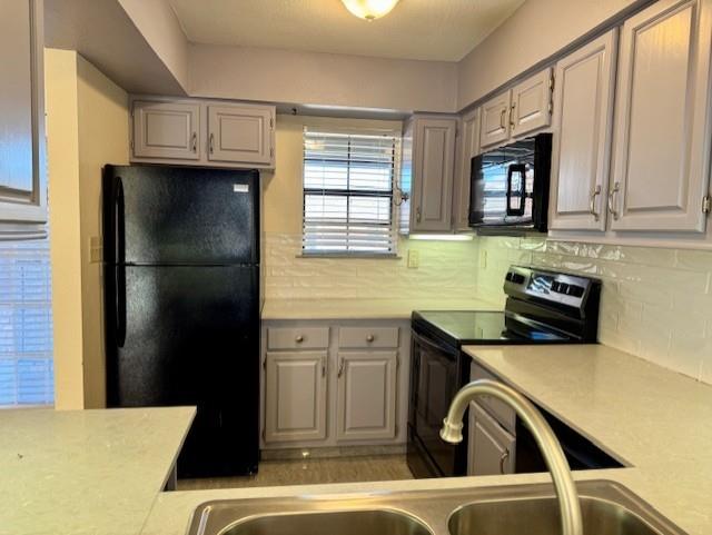 2733 Silver Creek Drive, Unit 205 Arlington, TX 76006 - Photo 5 of 13 a kitchen with a refrigerator and a sink
