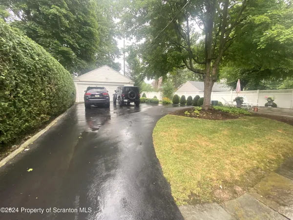 a view of a house with a yard and garage