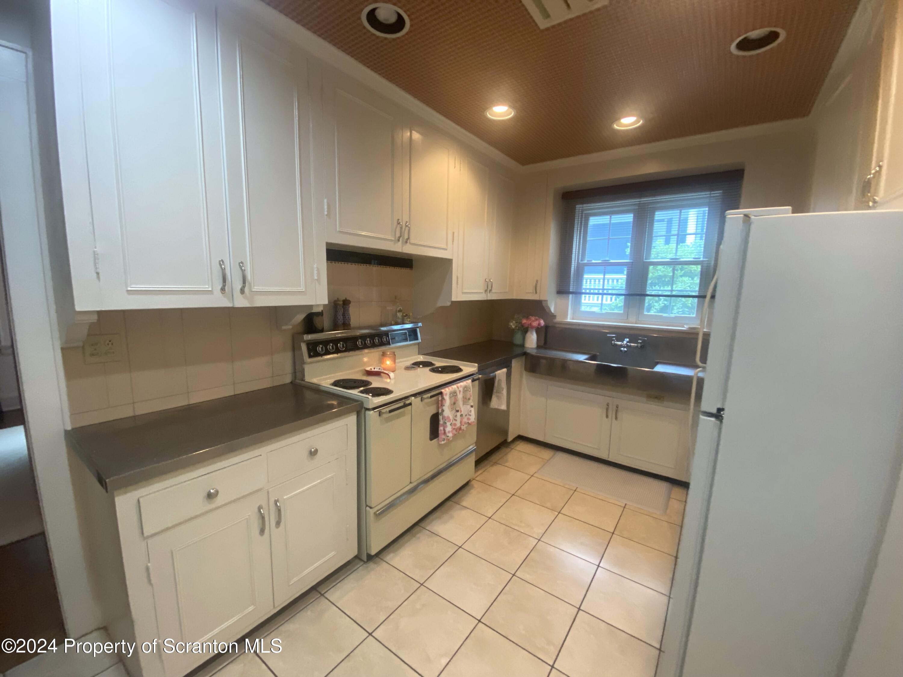 1008 Electric Street Scranton, PA 18509 - Photo 8 of 25 a kitchen with a white cabinets and white appliances