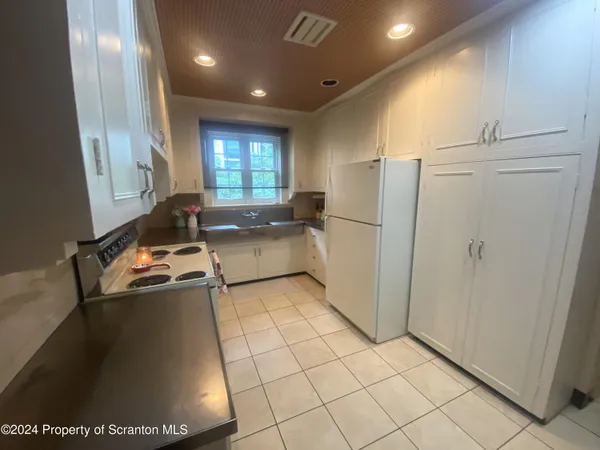 a kitchen with a refrigerator a stove a washer and dryer
