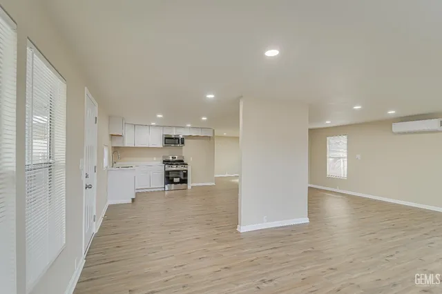 a view of a kitchen with a sink and wooden floor