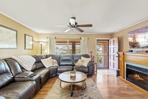 a living room with furniture a fireplace and a chandelier