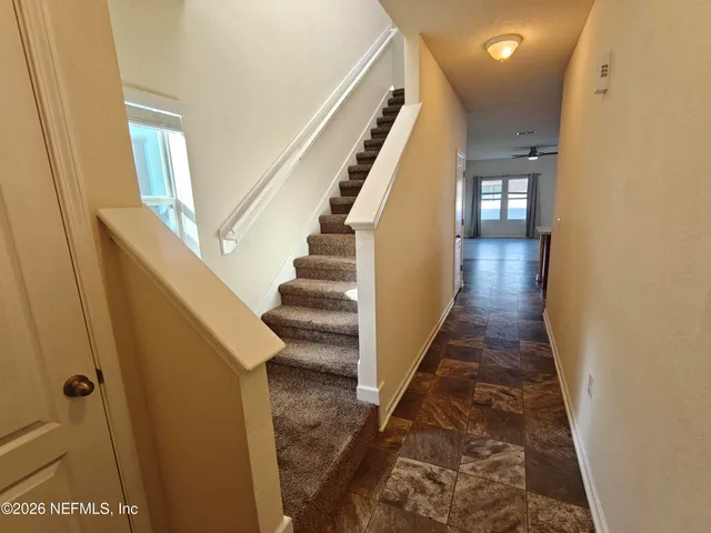 a kitchen with granite countertop a refrigerator and a sink