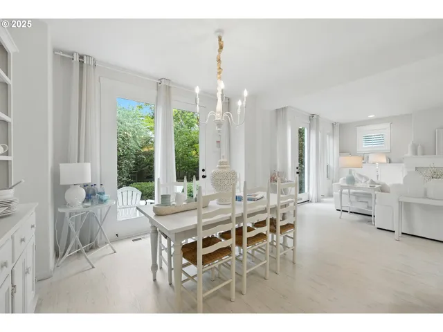 a kitchen with a table chairs stove and cabinets