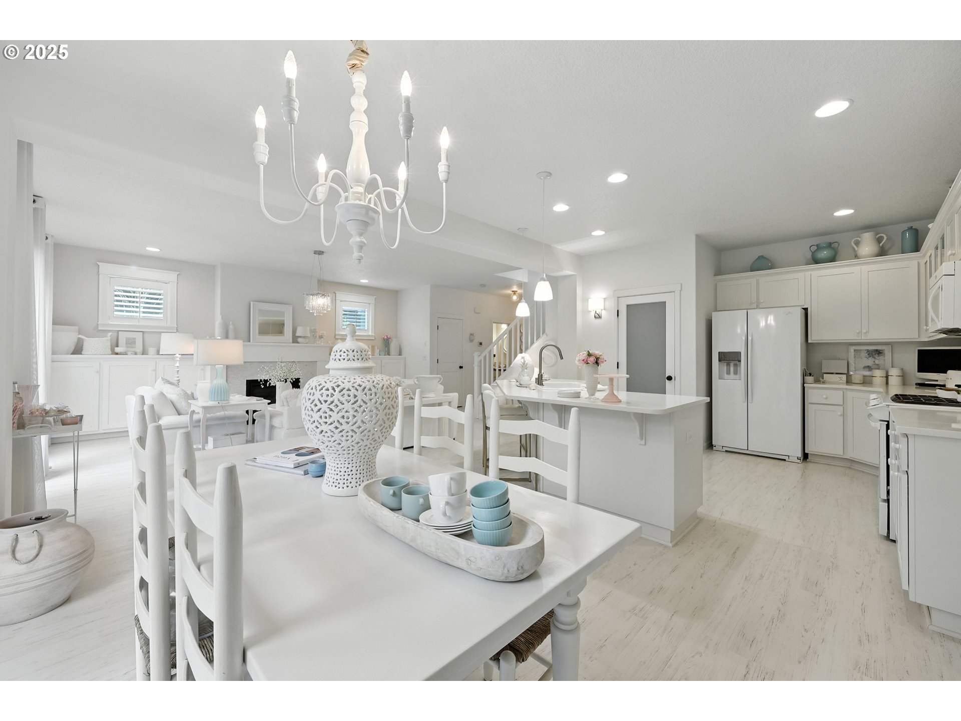 2210 South White Salmon Drive Ridgefield, WA 98642 - Photo 21 of 45 a kitchen with stainless steel appliances kitchen island granite countertop a refrigerator a stove a sink dishwasher and white cabinets with wooden floor