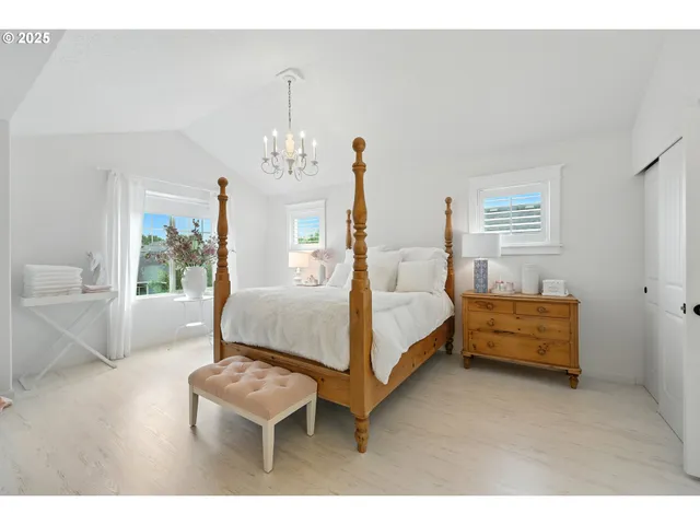 a bedroom with a bed and a potted plant