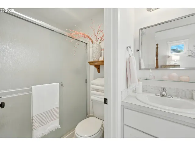 a bedroom with a large bed a chandelier and dresser