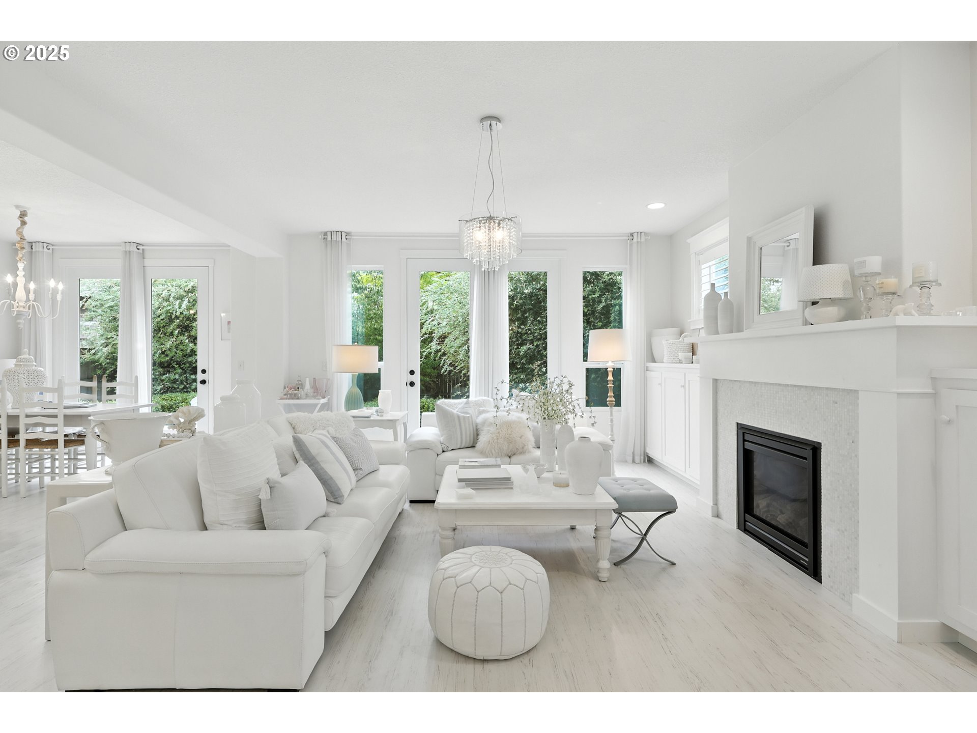 2210 South White Salmon Drive Ridgefield, WA 98642 - Photo 10 of 45 a living room with furniture a fireplace and a chandelier