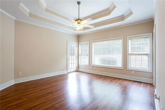 a view of an empty room with a chandelier fan